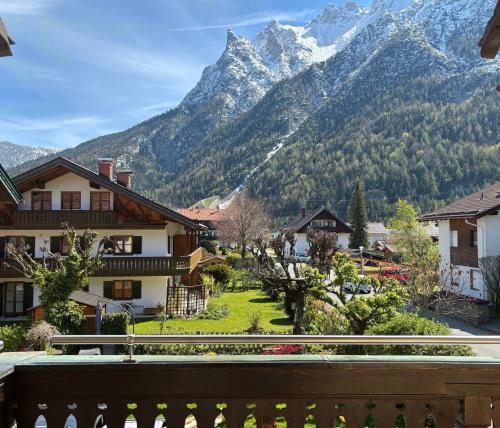 a view from a balcony of a village with a mountain at Pension Bavaria in Mittenwald