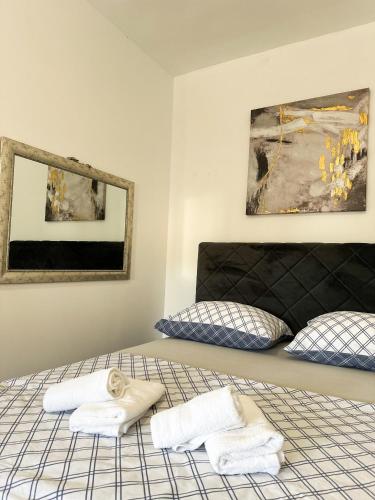 a bedroom with a bed with towels on it at Ronia apartment in Kaštela