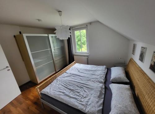 a bedroom with a bed and a window at Apartment Barbara in Velden am Wörthersee