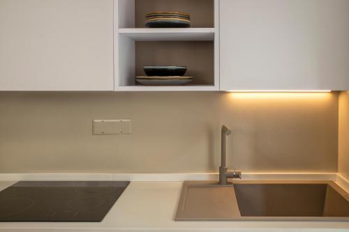 a kitchen with a sink and a counter top at Luxury Sofia Home Alghero in Alghero