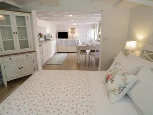 a bedroom with a bed and a kitchen with a table at Ty Hafan in Holywell