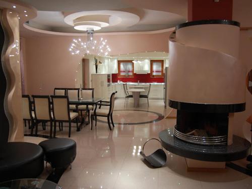 a living room with a dining table and a fireplace at Petrovski's Residence in Bitola