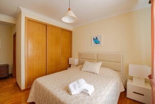 a bedroom with a bed with two towels on it at Remédios Apartment in Lamego