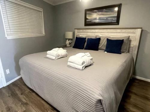 a bedroom with a large bed with towels on it at Beachin It!-Oceanview Updated 2024, King Bed Bikes in Hilton Head Island