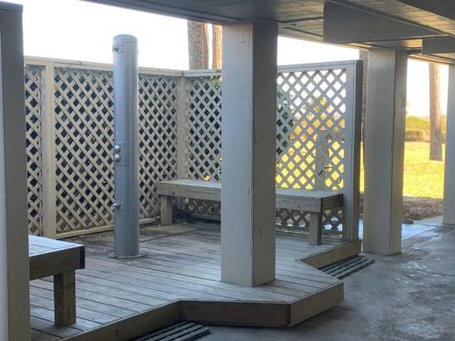 a porch with two benches on a wooden deck at Beachin It!-Oceanview Updated 2024, King Bed Bikes in Hilton Head Island