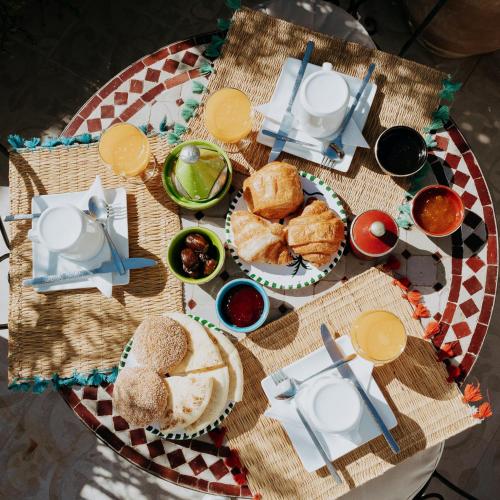 a table topped with plates of food and drinks at Riad Zayane Atlas in Marrakech