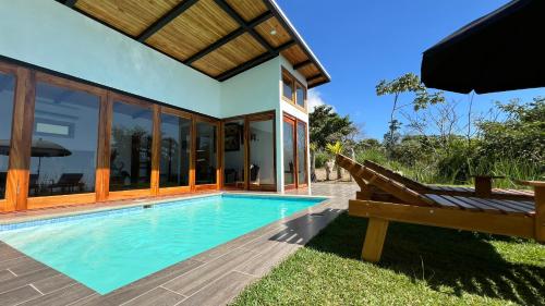a villa with a swimming pool and a house at Canavida Villas & Resort in Uvita