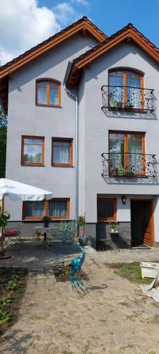 a large white house with a table in front of it at la Brigitte in Hennigsdorf