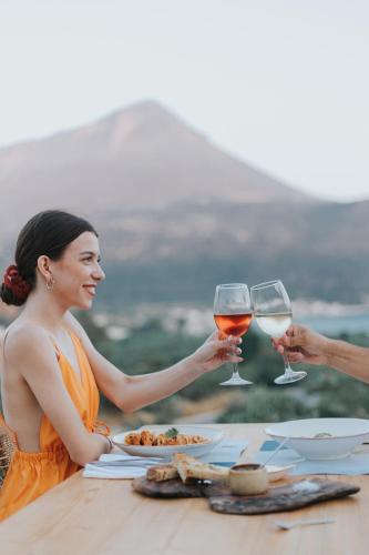 a group of people sitting at a table with wine glasses at Brazzo di Maina in Oítilon
