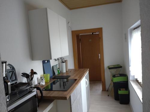 a kitchen with white cabinets and a counter top at Gästezimmer M. Schubert in Oberelbert