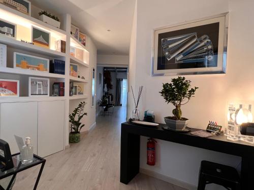 a living room with a table and shelves at LOFT29 Design home near the Vatican in Rome