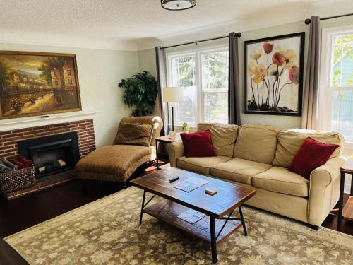 a living room with a couch and a fireplace at State Street Cottage, Suite 2 in Pullman