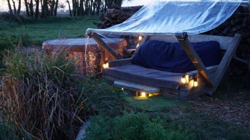 a couch in a hammock with lights in a yard at Auszeit inmitten der Natur - its a kind of magic in Freienthal