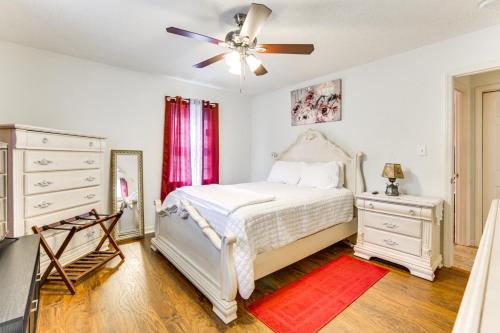 a bedroom with a white bed and a ceiling fan at Chatham Getaway with Fireplace, Deck and Gas Grill! in Chatham