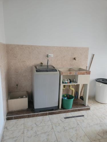 a small refrigerator in a corner of a room at HOSTAL S Y S in Cali