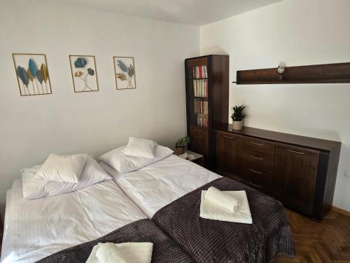 a bedroom with a large white bed with two pillows at Apartament Lawenda in Stary Sącz