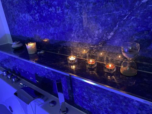 a blue counter with candles and lights on it at Il Sogno delle Rondini in Palidoro
