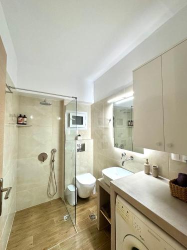 a bathroom with a toilet and a sink and a shower at Moretti Studios in Gythio