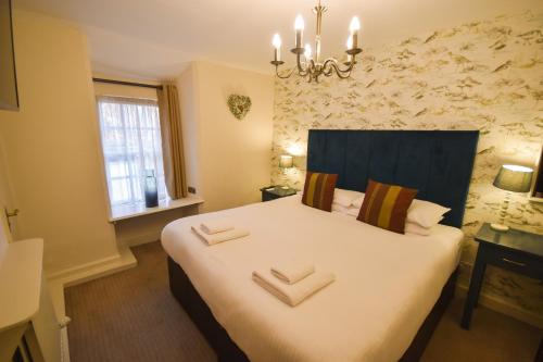 a bedroom with a bed with two pillows on it at Red Lion Inn in Hawkshead