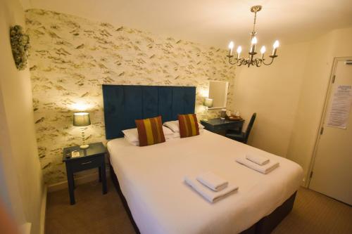 a bedroom with a large bed with two towels on it at Red Lion Inn in Hawkshead