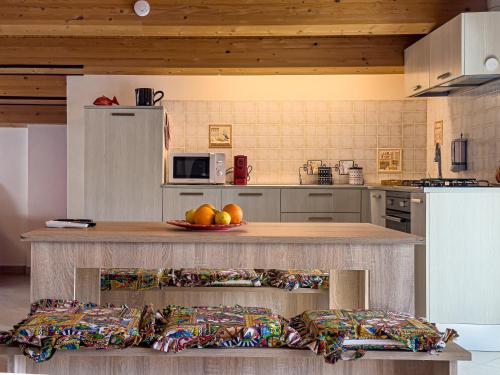a kitchen with a counter with fruit on it at Villa Donata Fontane Bianche in Fontane Bianche