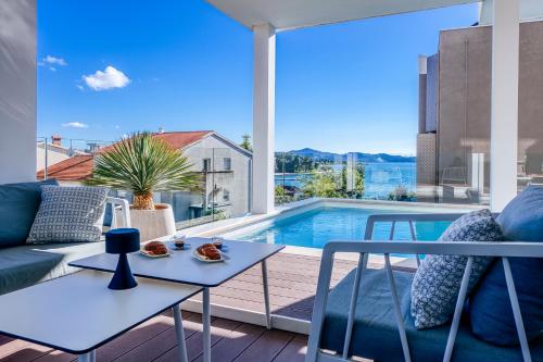 a living room with a couch and a table at Dedaj Resort - Villa Delux in Zadar