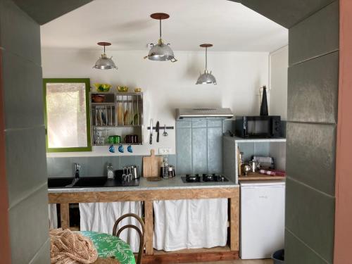 a small kitchen with a counter and a sink at Casa Bauxells in Sahorre