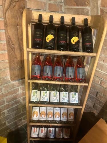 a rack of bottles of soda in front of a statue at Sklep u Dušana in Vracov