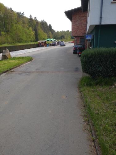an empty street with cars parked on the side of a building at Gästezimmer M. Schubert in Oberelbert