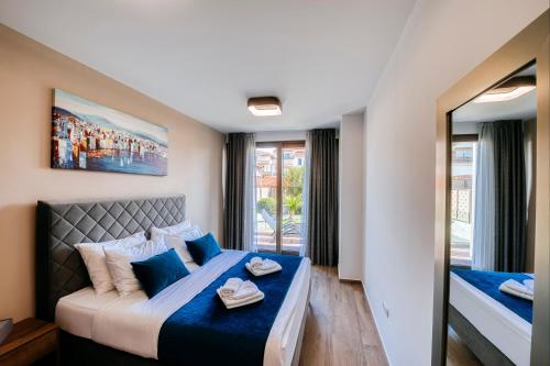 una camera da letto con un grande letto con cuscini blu di Dedaj Resort - Villa Delux a Zara (Zadar)