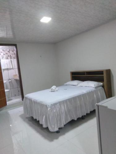 a bedroom with a bed in a white room at HOTEL NOVAES in Castanhal