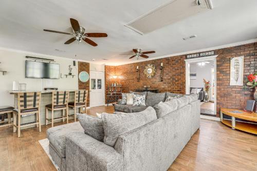 a living room with a couch and a bar at Screened Porch and Grill Spacious Charleston Home! in Charleston