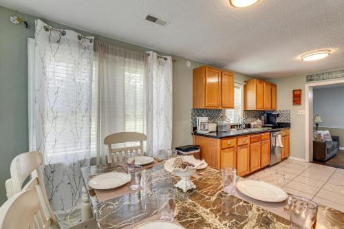 a kitchen with a dining table and a counter top at Screened Porch and Grill Spacious Charleston Home! in Charleston