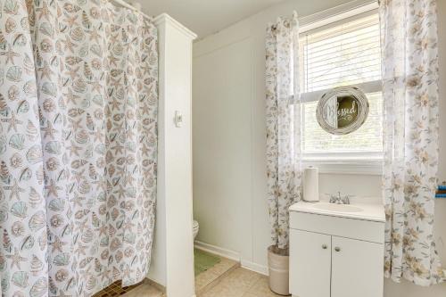 a bathroom with a sink and a shower curtain at Screened Porch and Grill Spacious Charleston Home! in Charleston