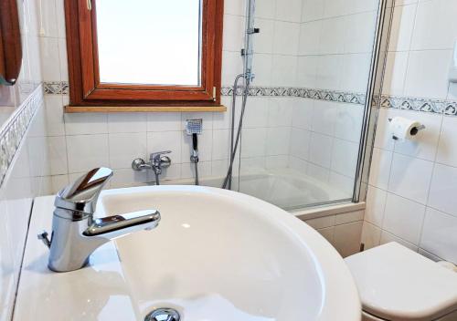 a bathroom with a sink and a toilet at Aida Guest House - Decimomannu in Decimomannu