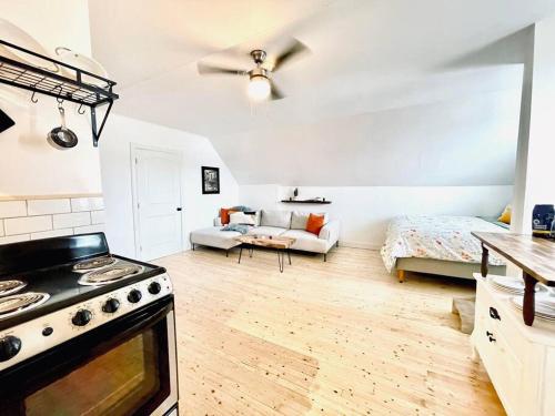 a kitchen with a stove and a bed in a room at Finn's Studio, Fundy Park in Alma