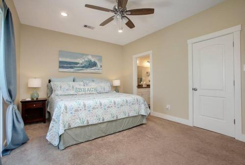 a bedroom with a bed and a ceiling fan at 3 BR Beach view in Galveston