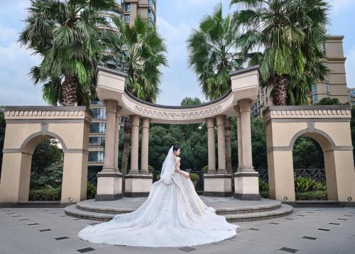 a bride in a wedding dress in front of a building at The Azure Ningbo, Vignette Collection in Ningbo