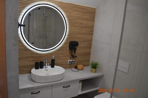 a bathroom with a sink and a mirror at Apartament Zakopiański Relax in Zakopane