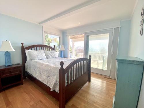 a bedroom with a bed and a large window at Beach Front Luxury Vacation Rental On Lbi in Surf City