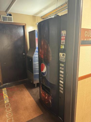 a vending machine is next to a wall at Mitchell Inn in Mitchell