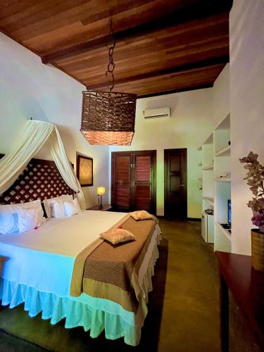 a bedroom with a large bed in a room at Casa de São José Hotel Boutique in Camocim