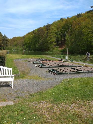 a park with a white bench next to a bunch of debris at Gästezimmer M. Schubert in Oberelbert