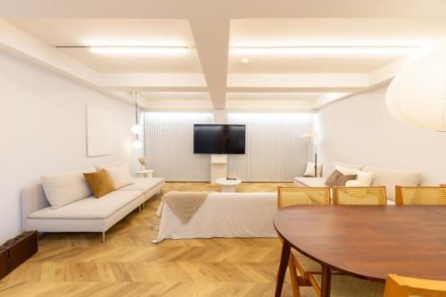 a living room with a couch and a table at CITY HOTEL UMEDA Residence in Osaka