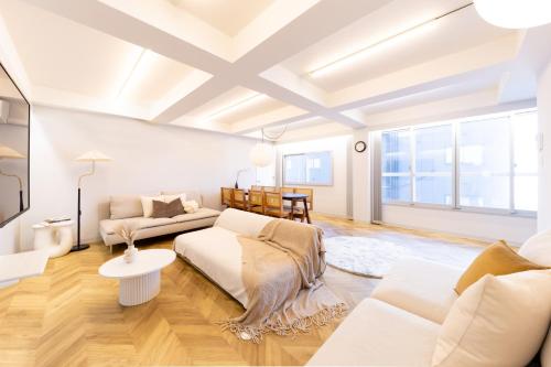 a living room with a couch and a table at CITY HOTEL UMEDA Residence in Osaka