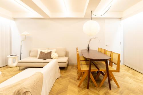 a living room with a table and a couch at CITY HOTEL UMEDA Residence in Osaka