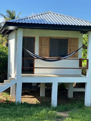a hammock in front of a tiny house at Silversands Retreat SA in Corn Island