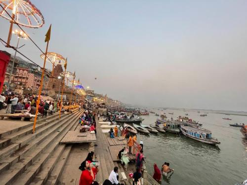 a group of people standing on a pier near the water at Hotel Ananya Inn in Varanasi