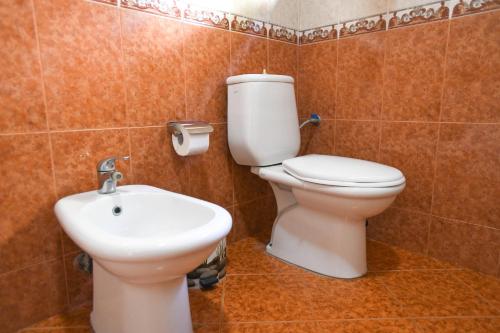 a bathroom with a toilet and a sink at Rezidenca Aurel Center in Berat