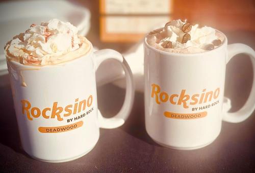 two coffee mugs sitting on top of a table at Rocksino by Hard Rock Deadwood in Deadwood
